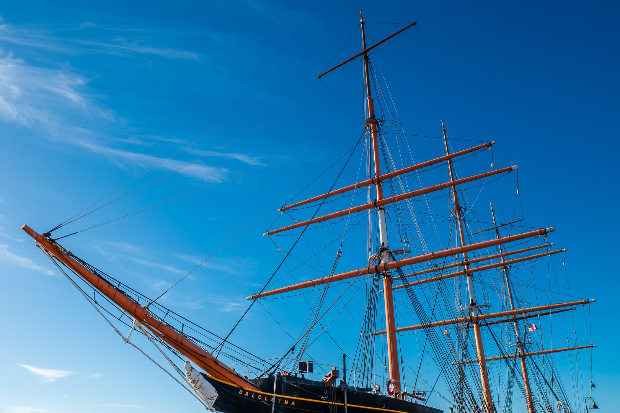 The masts of the Balclutha, a full-rigged ship built in 1886, rise into the blue Bay Area sky at the San Francisco Maritime National Historical Park.