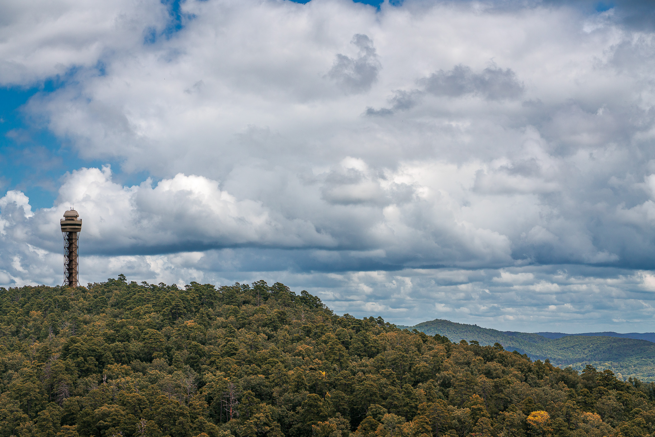 The Hot Springs Mountain Tower rises over the forested landscape of Arkansas' Hot Springs National Park.