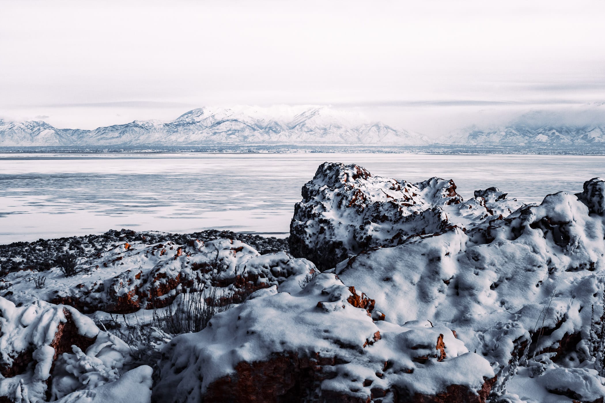 Snow-covered rocks on the shore of Utah's Great Salt Lake at Antelope Island.