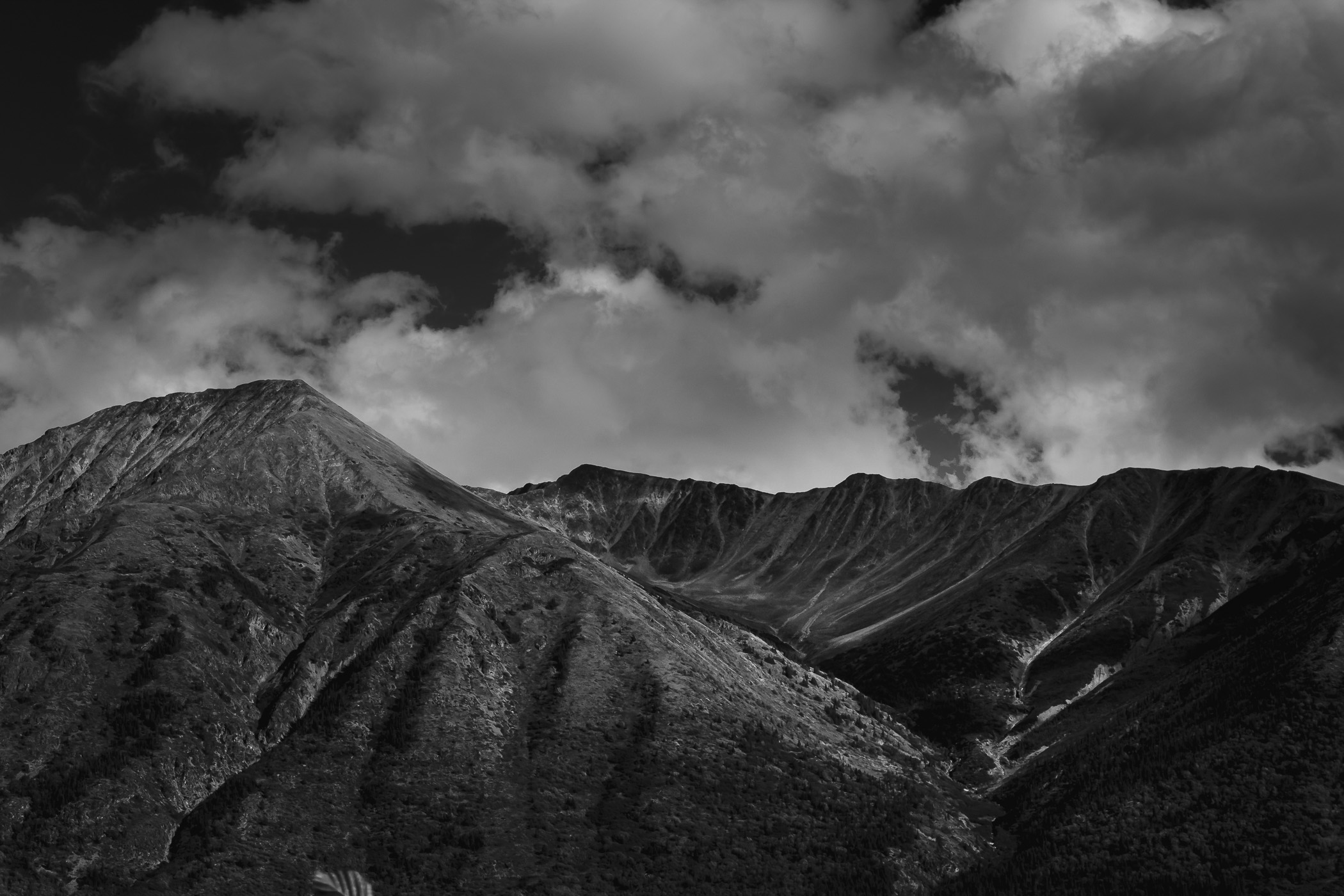 Mountain peaks in the cloud sky near Tagish Lake, Yukon Territory, Canada.