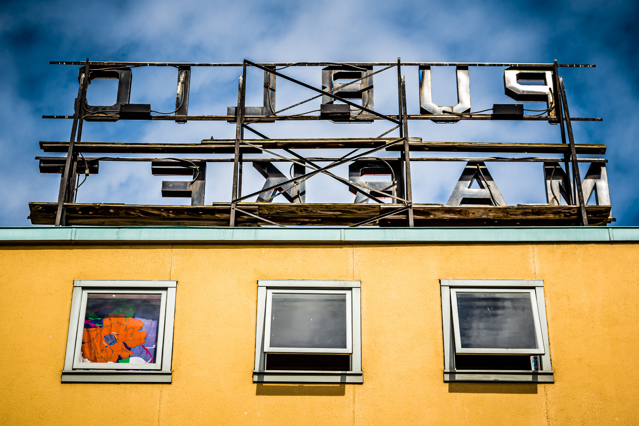 Three windows under a sign at Seattle's Pike Place Market.