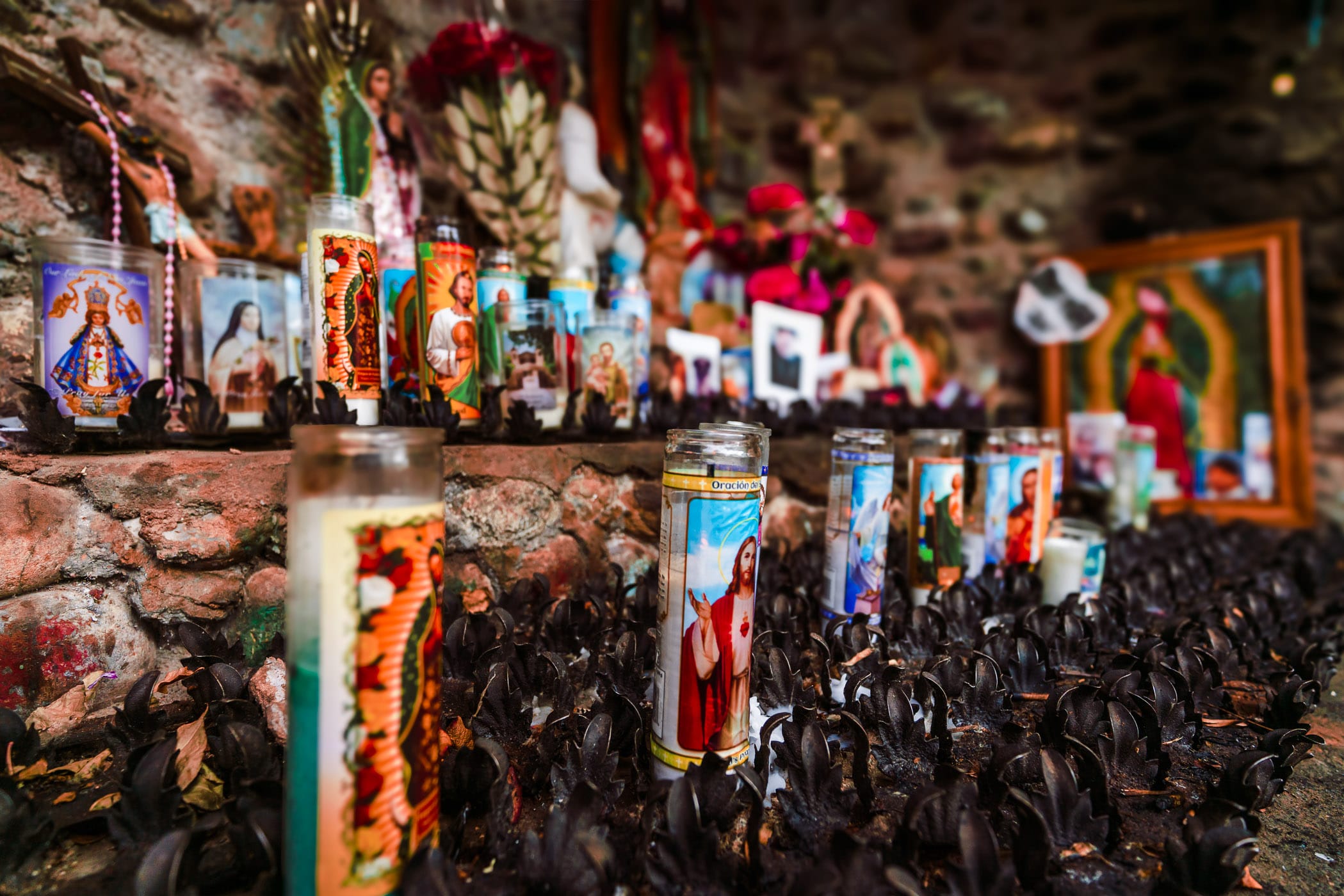 Votive candles in a shrine at the Santuario de Chimayó in Chimayó, New Mexico. 