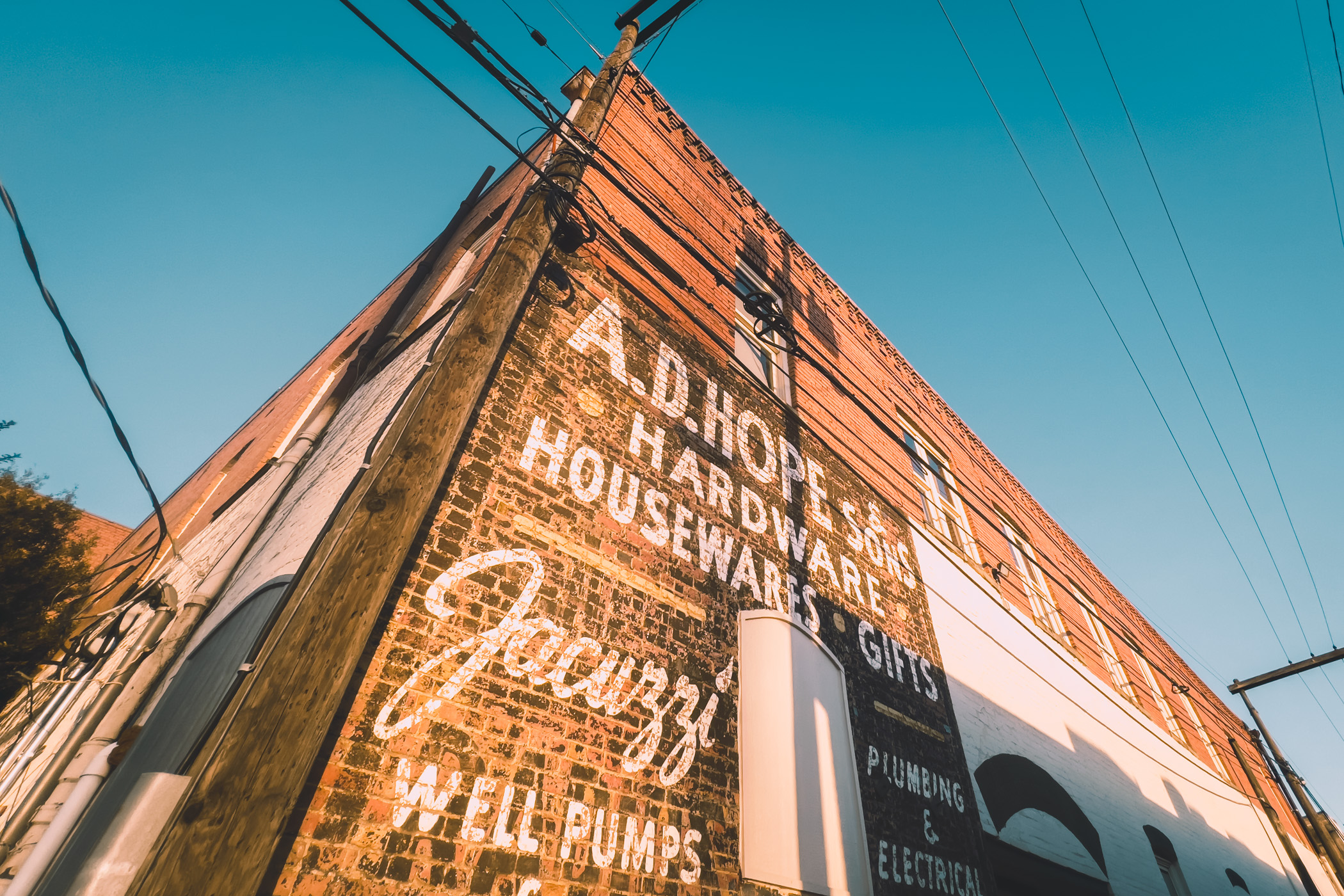 A faded sign on the side of a building in Downtown McKinney, Texas.