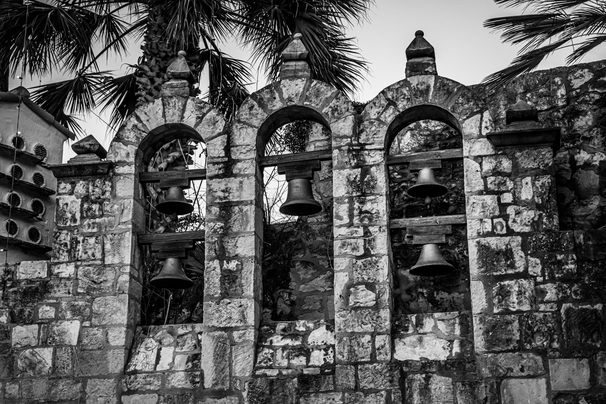 Old bells set in the stonework of San Antonio, Texas' Arneson River Theatre along the city's Riverwalk.