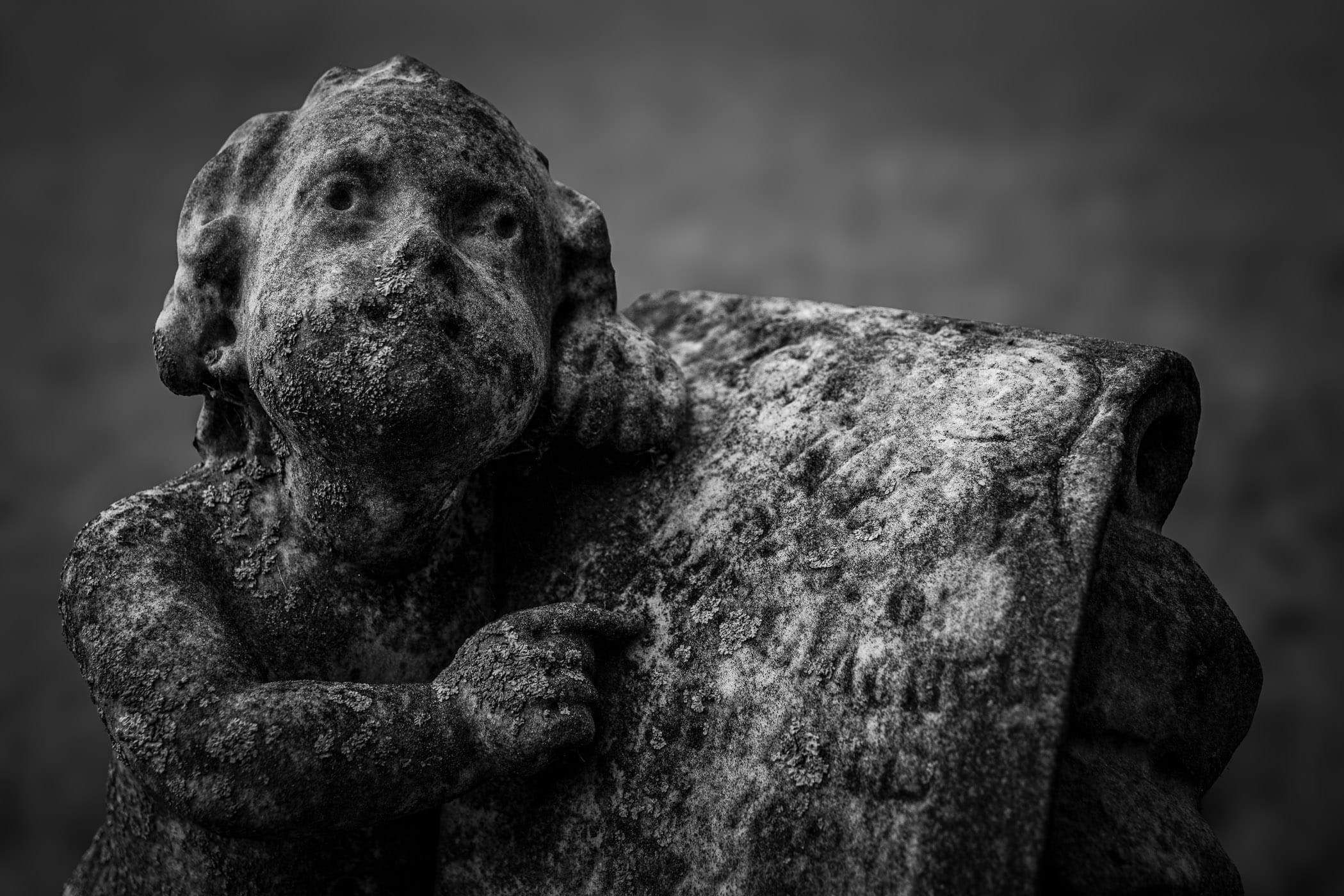 A vaguely-creepy statue of a cherub adorns a gravestone in Pecan Grove Cemetery, McKinney, Texas.