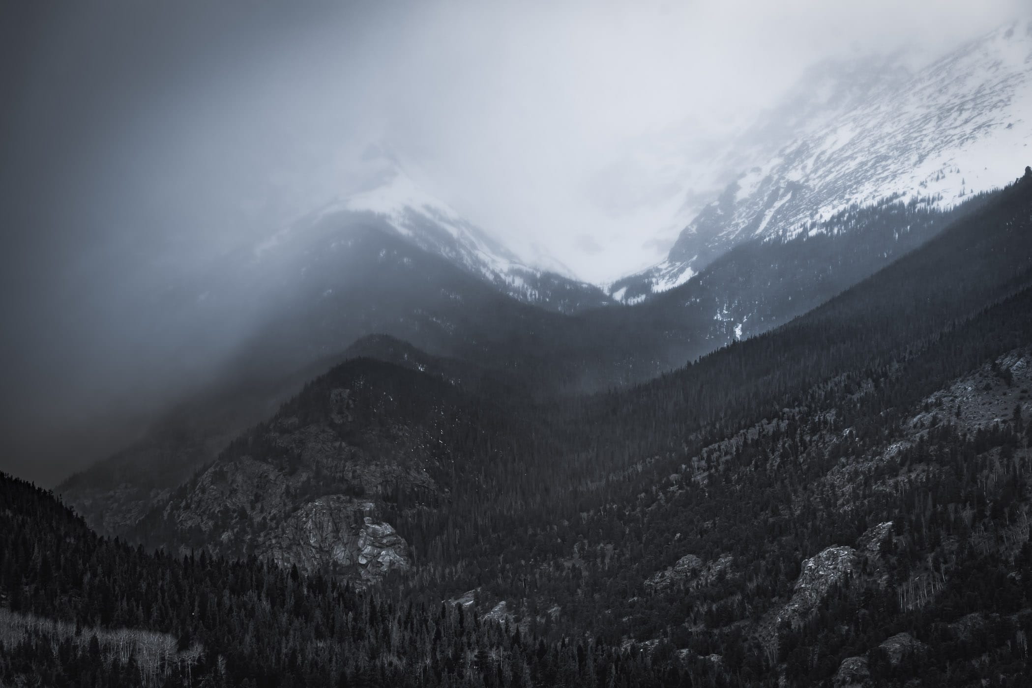 A late-winter storm blows in over the snowcapped mountains of Colorado's Rocky Mountain National Park.