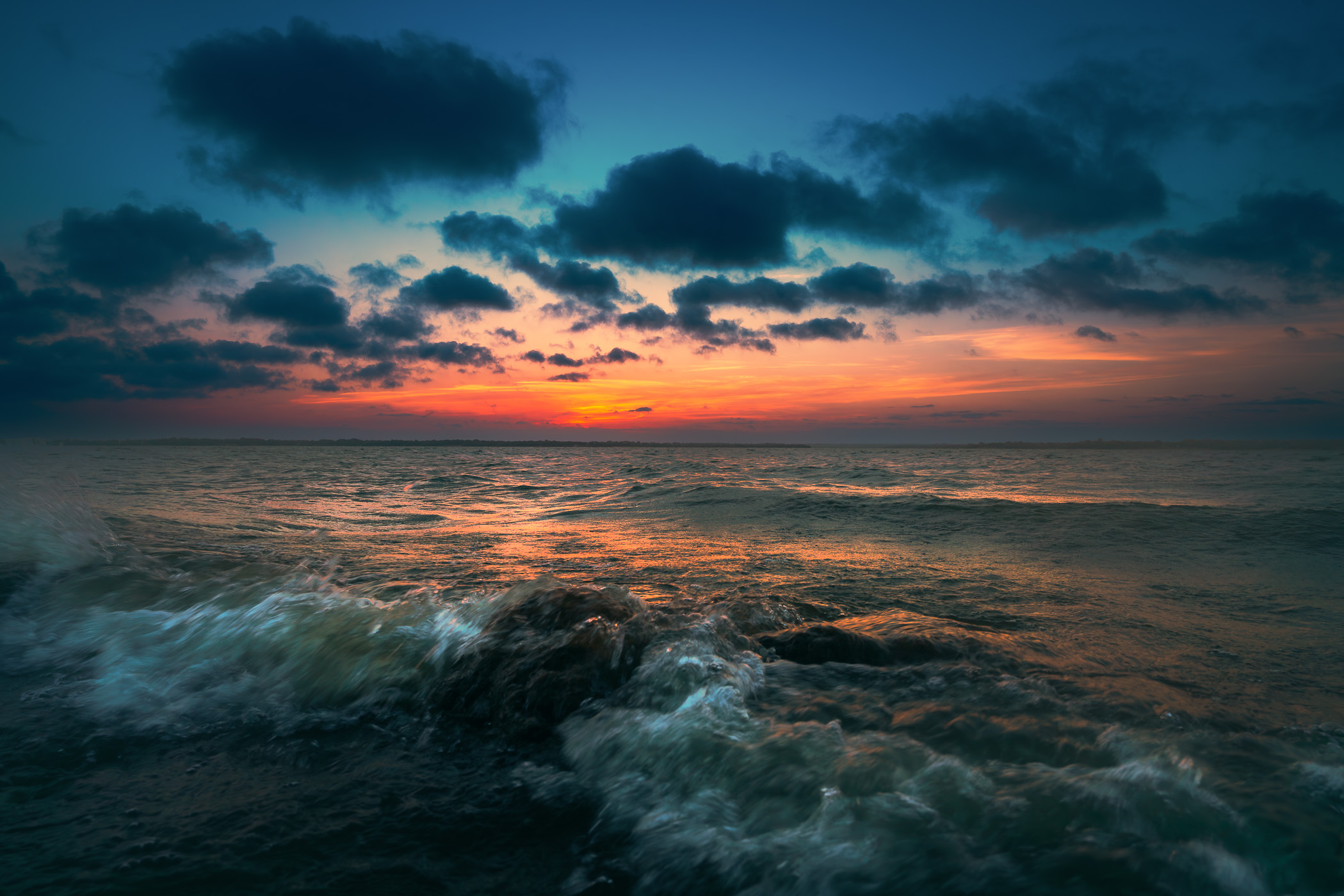 Waves splash over rocks on the shore of North Texas' Lake Lavon.