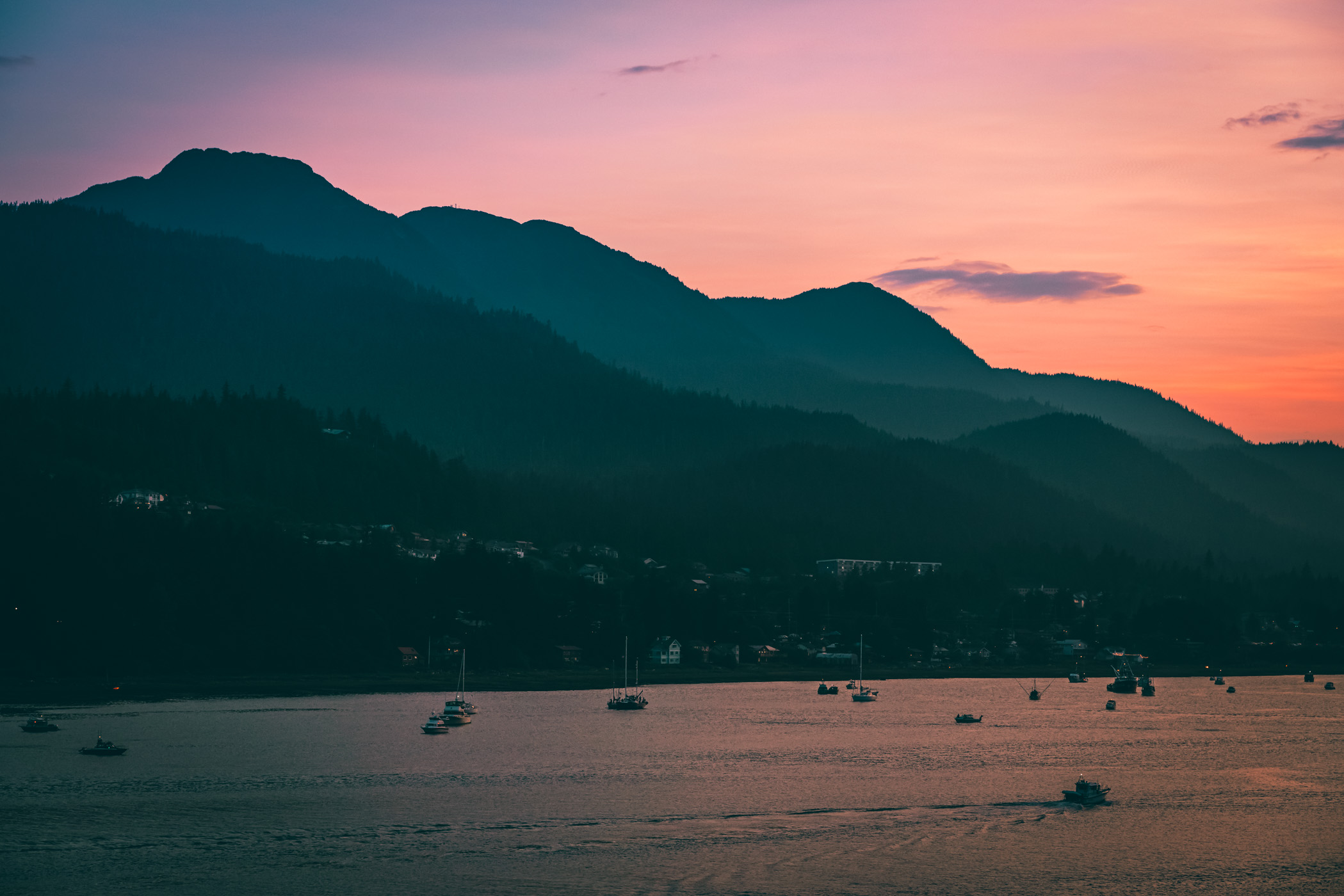 The sun sets on the far side of the mountainous Douglas Island, Juneau, Alaska.