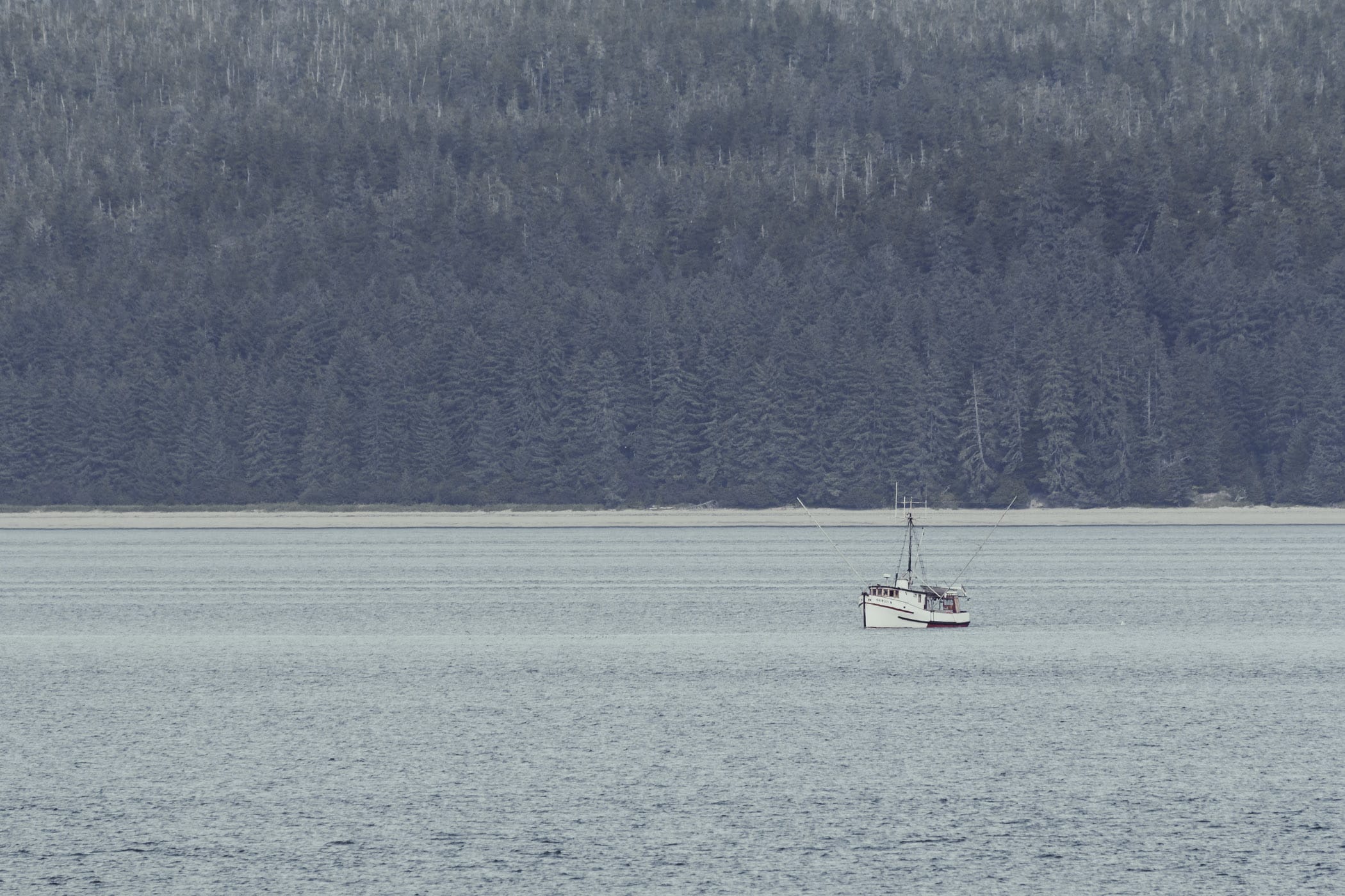 A fishing vessel trawls the waters of Alaska's Glacier Bay National Park.