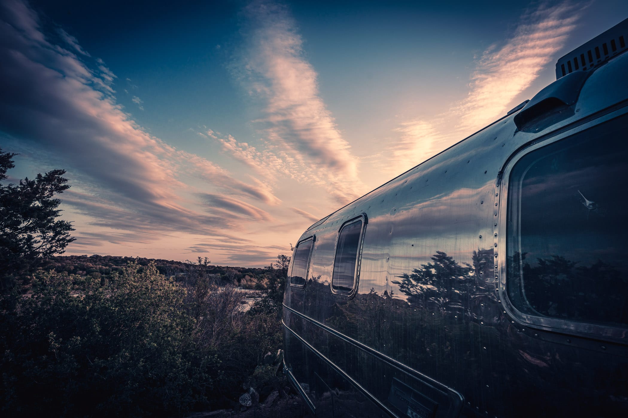 The sunsets on an Airstream trailer on a bluff overlooking the LLano River near Mason, Texas.