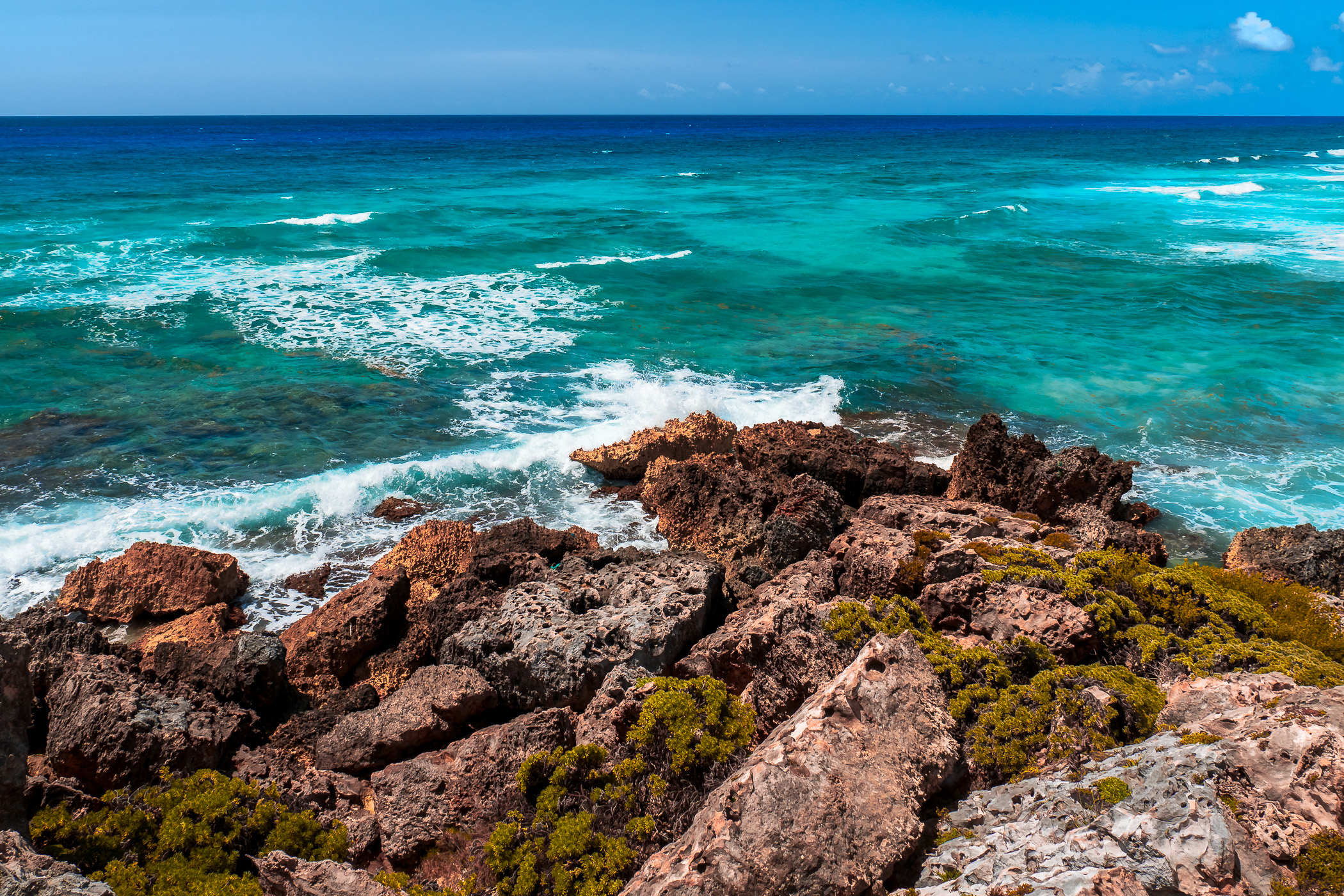 Waves crash onto rocks at Playa Chumul, Cozumel, Mexico.