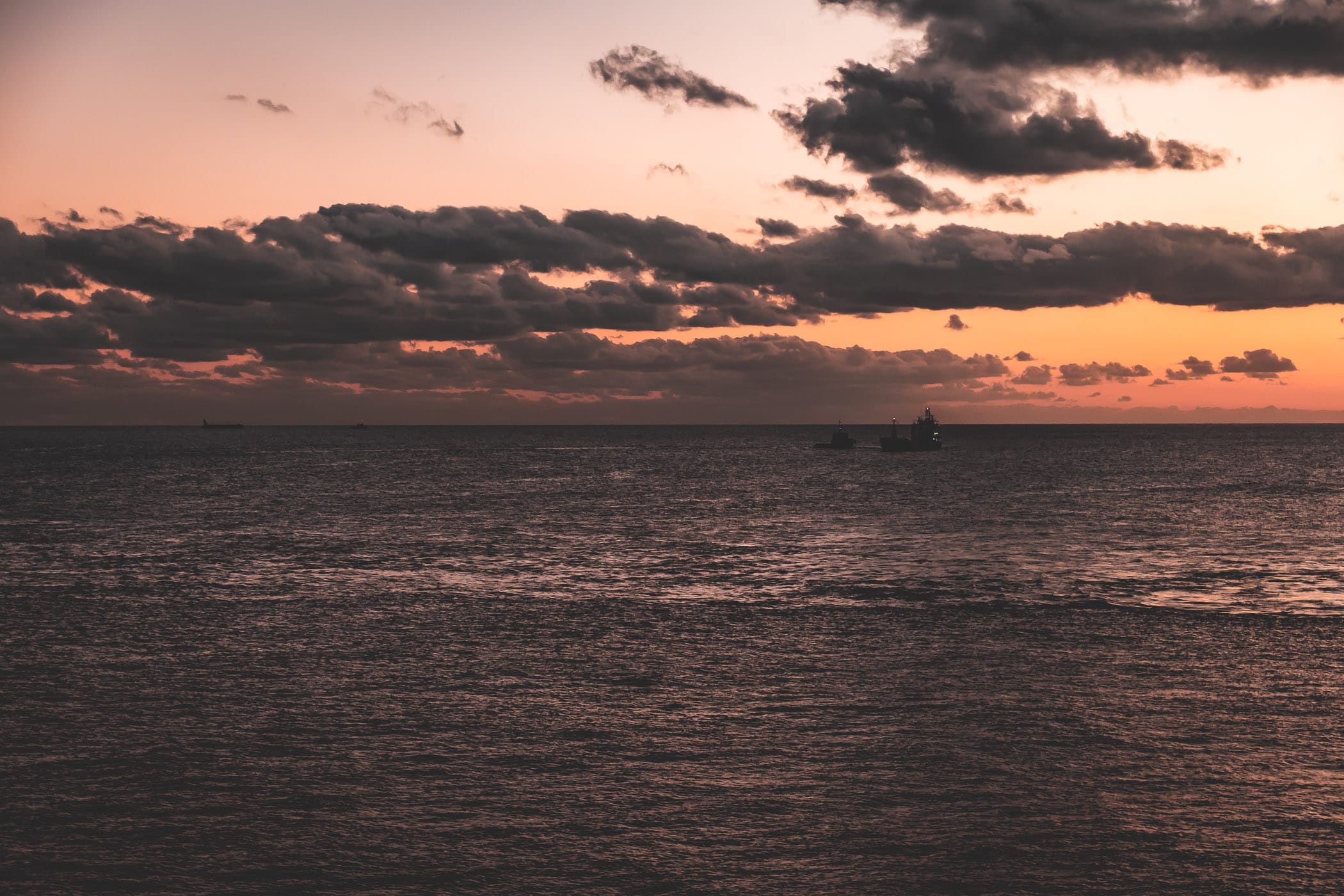 The sun sets on the Caribbean Sea off the coast of George Town, Grand Cayman.