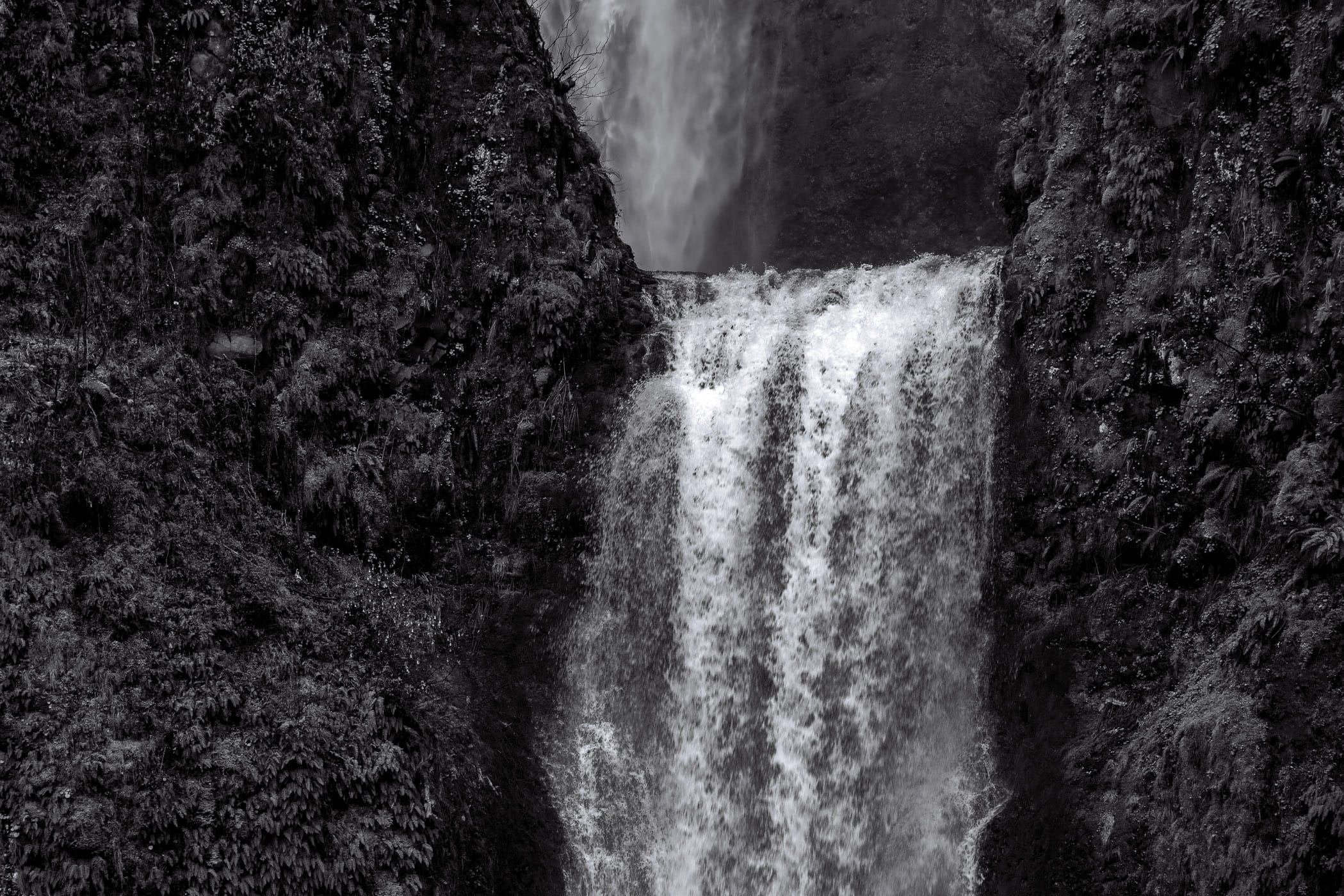 Water flows over the rim of the lower level of Oregon's Multnomah Falls.