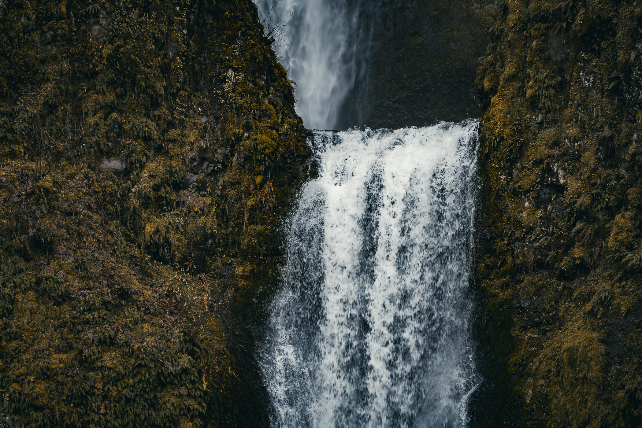 Water flows over the rim of the lower level of Oregon's Multnomah Falls.