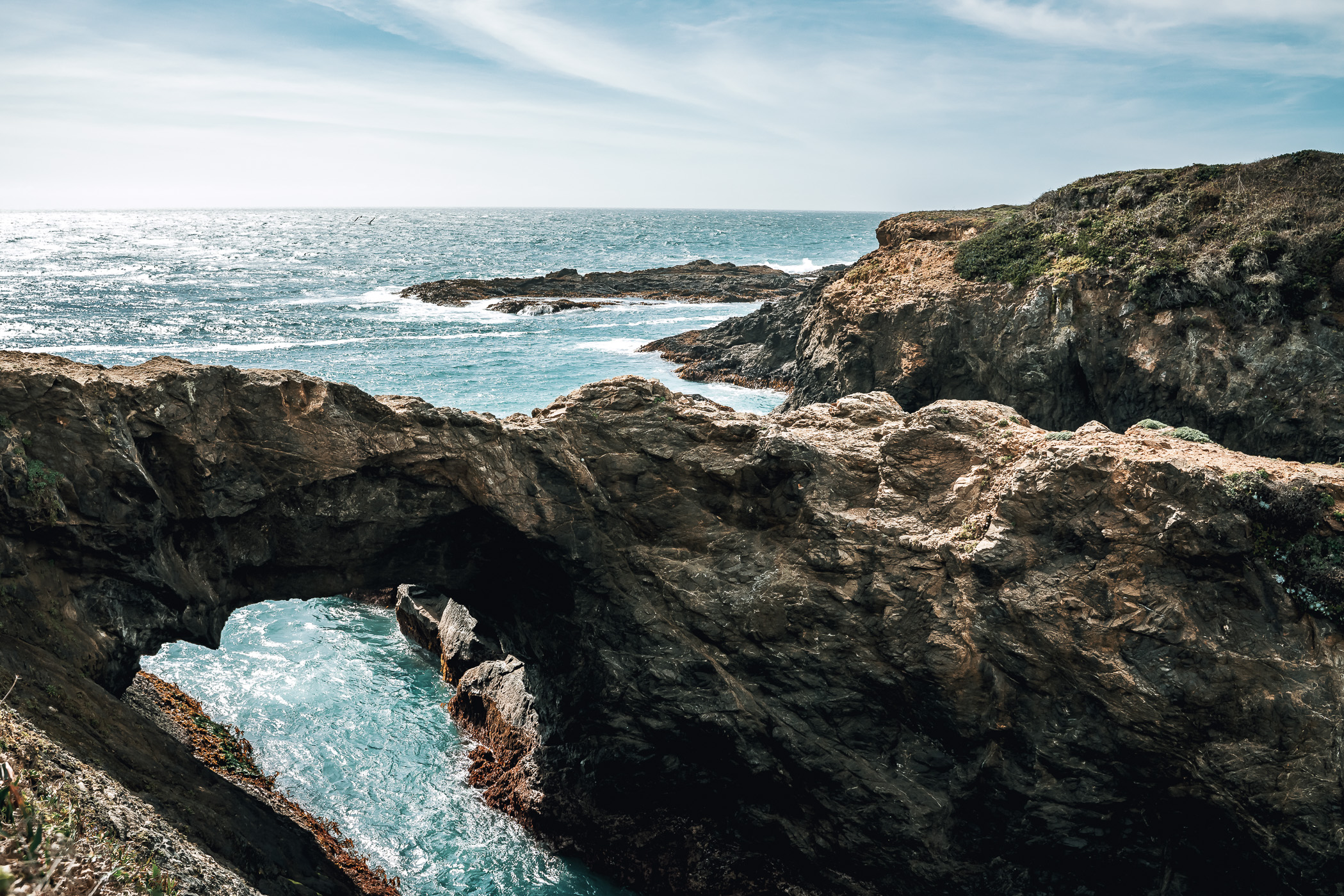 A rock arch bridges a gap on Point Mendocino at Mendocino, California.