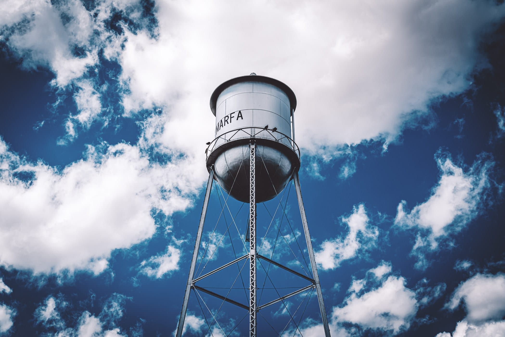 Marfa, Texas' water tower stands among the West Texas clouds.