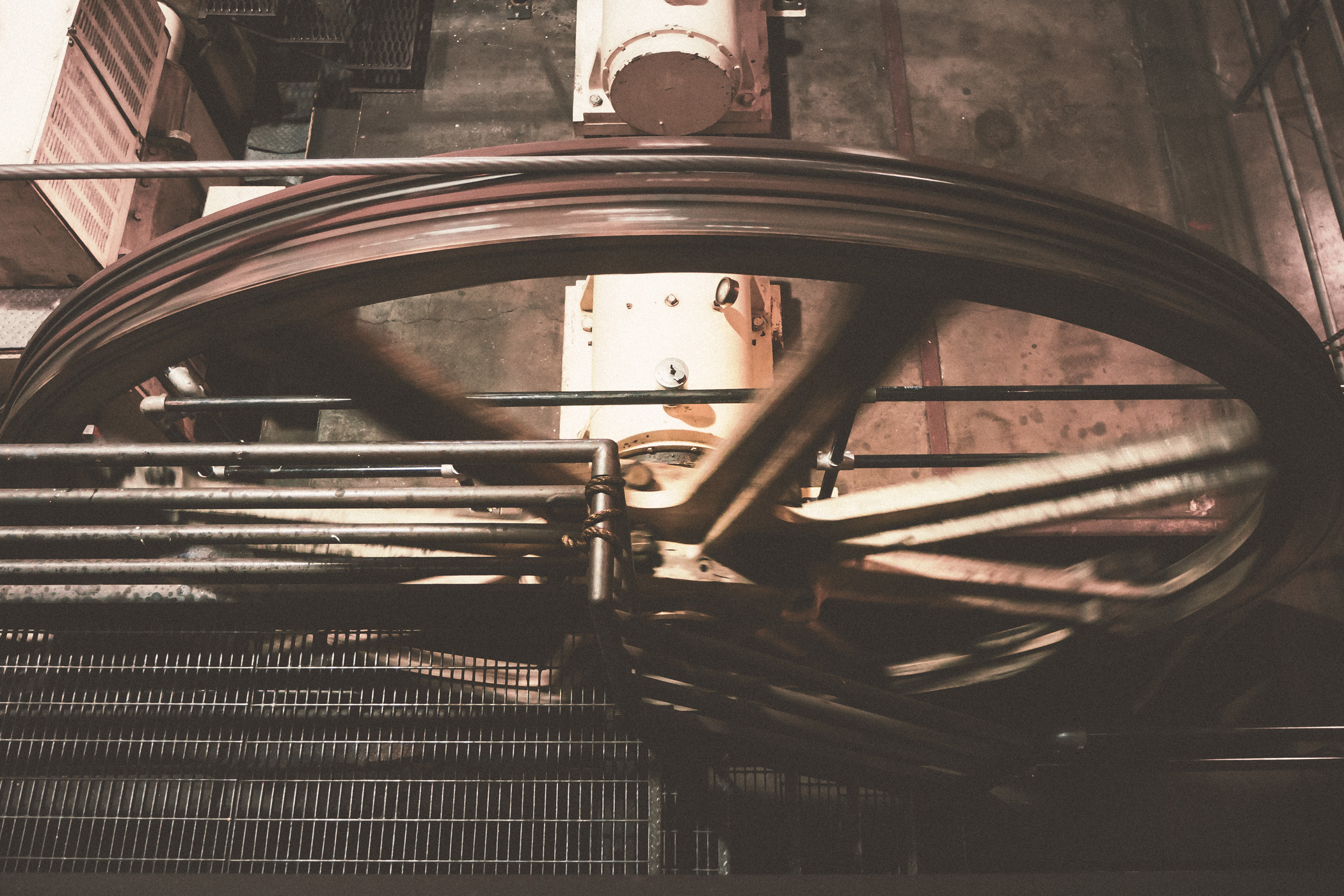 One of the six 14-ft. diameter wheels (or sheaves) that pull the cable haulage for San Francisco's three cable car lines spin non-stop at the cable car powerhouse and museum in the historic Nob Hill neighborhood.