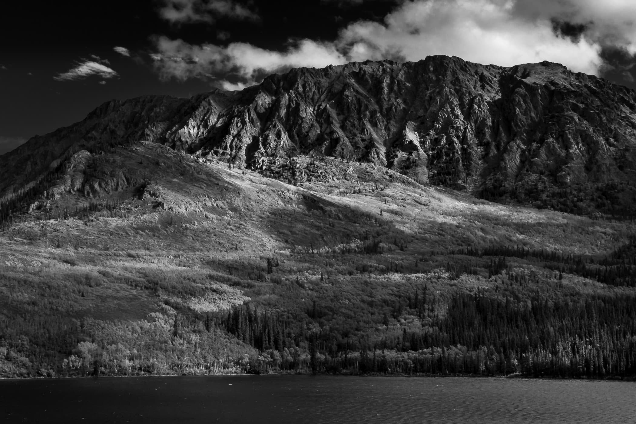 A rugged mountain towers over Tagish Lake near Atlin, British Columbia.