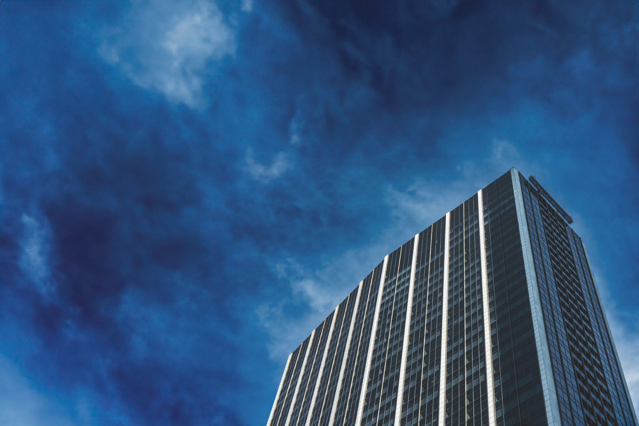 The National—originally built as the First National Bank Tower in 1965 and formerly known as Elm Place—rises into the Downtown Dallas sky.