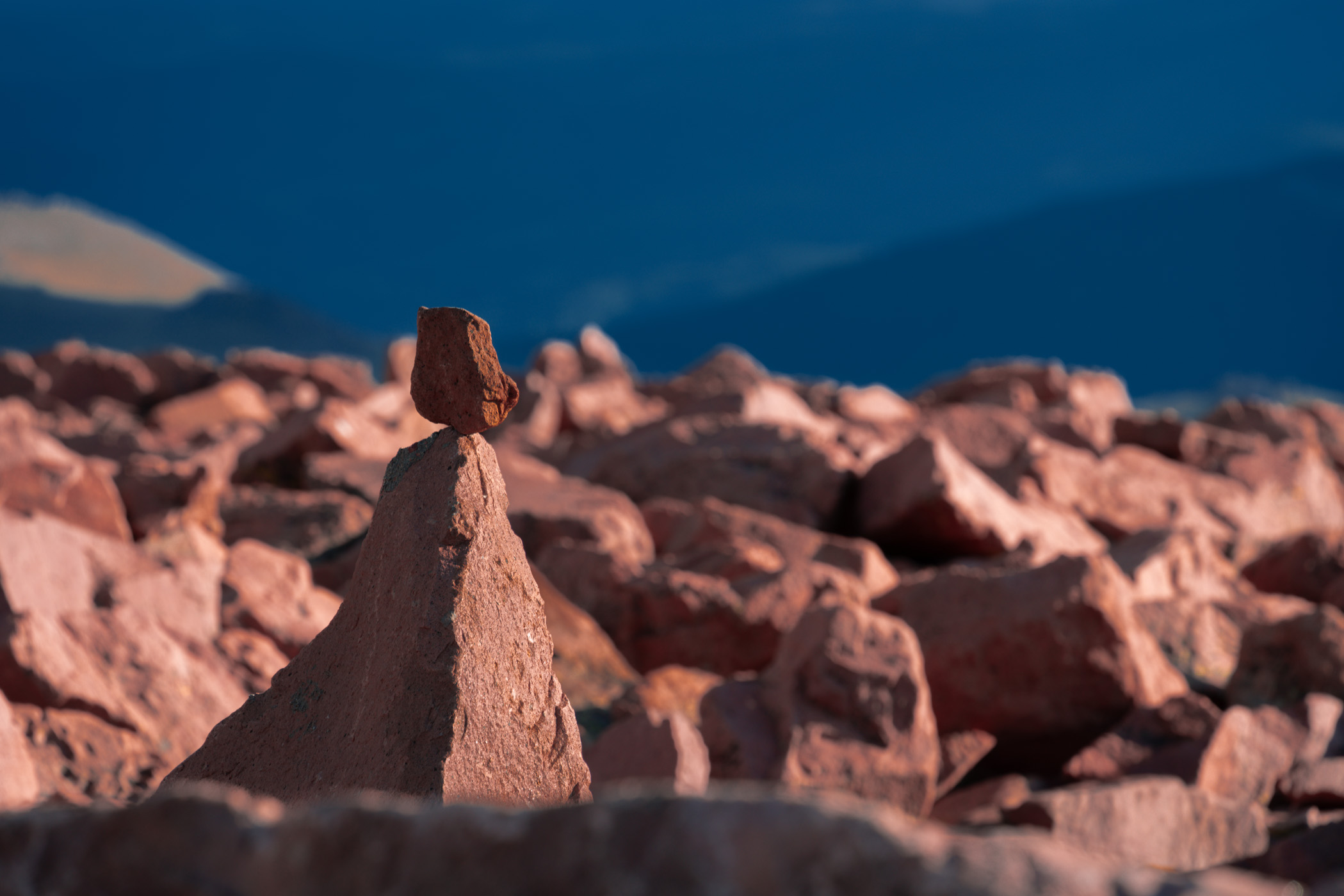 A rock balanced atop another among the thousands of rocks at the summit of Pikes Peak, Colorado.