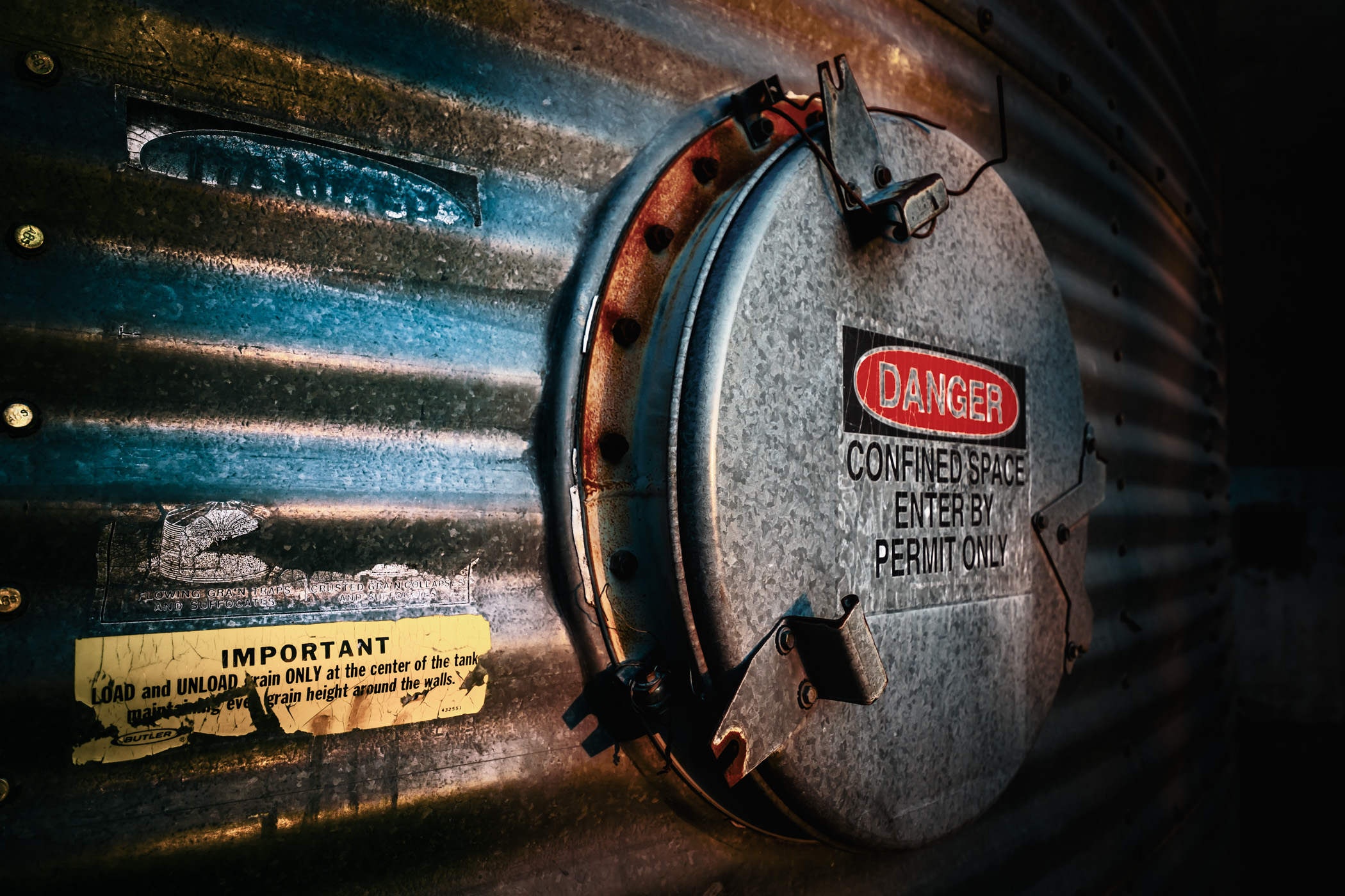 An access hatch and its accompanying warning signs spotted on an old silo near Downtown McKinney, Texas.