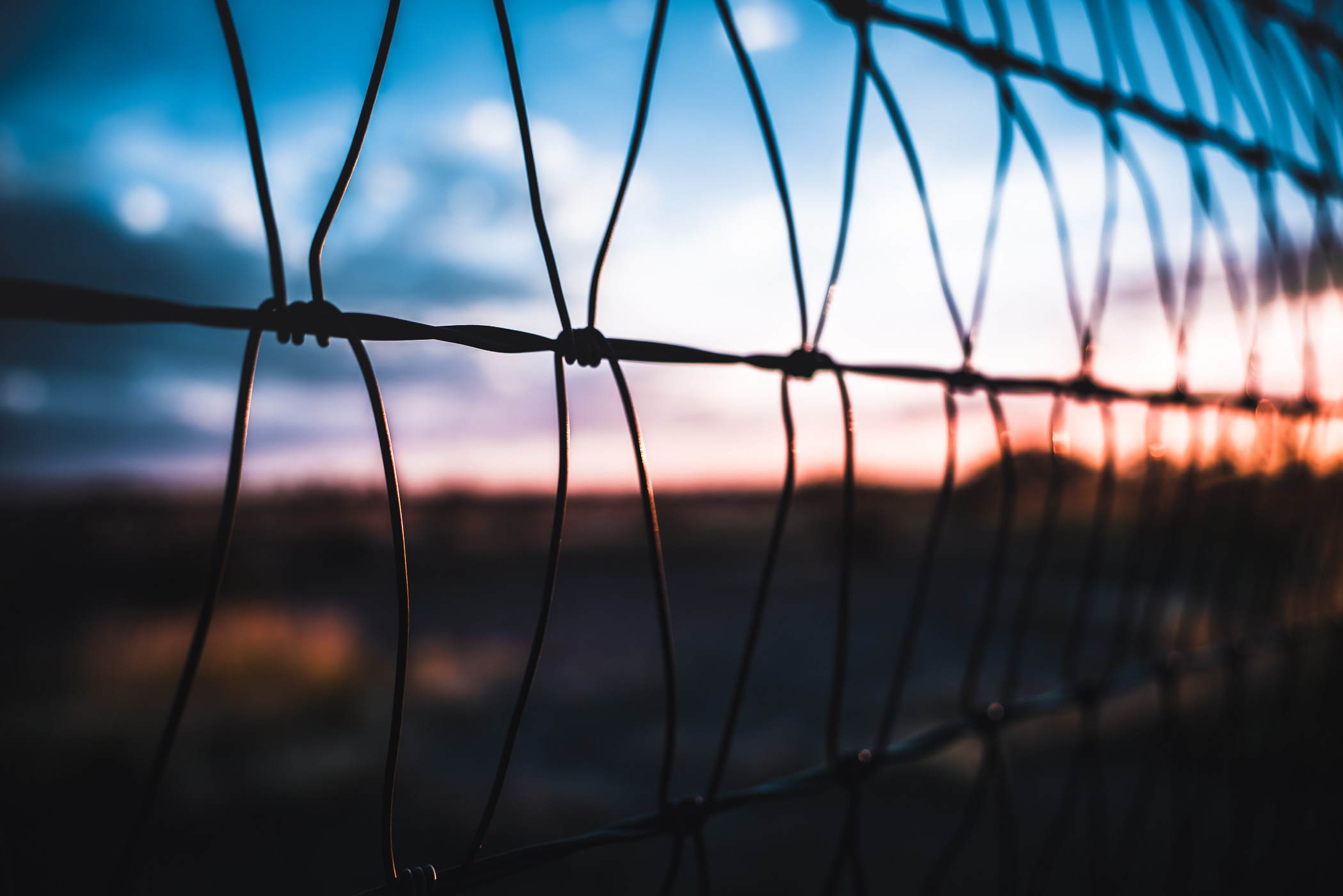 A wire fence along a property line in the West Texas desert near Marfa.