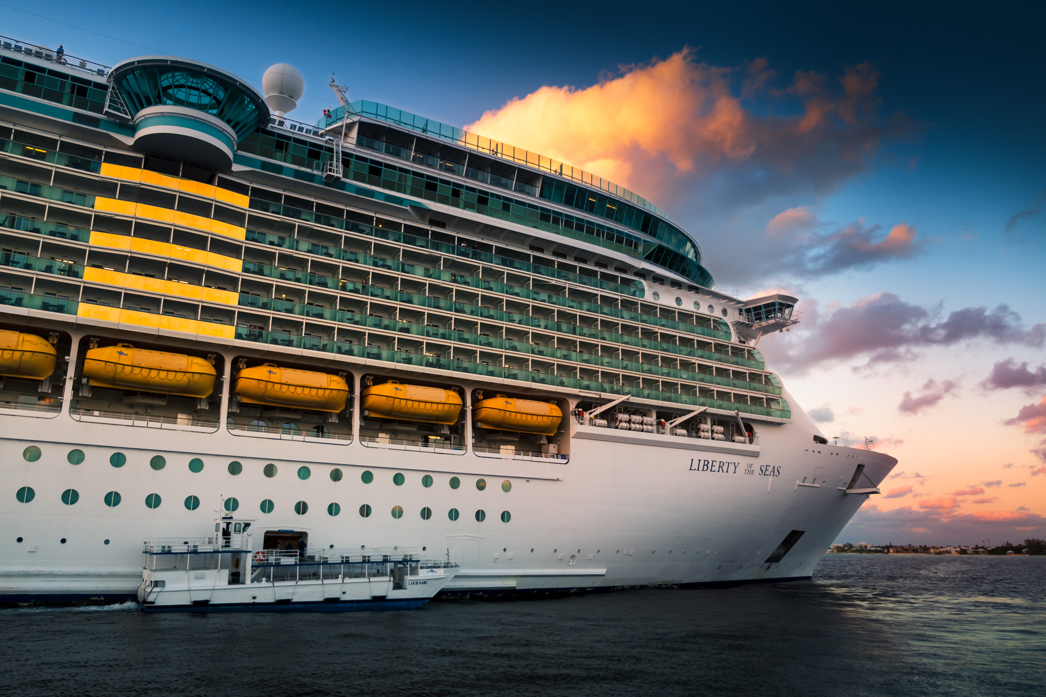 A ship's tender snuggles up next to the Royal Caribbean cruise ship Liberty of the Seas off the coast of George Town, Grand Cayman.