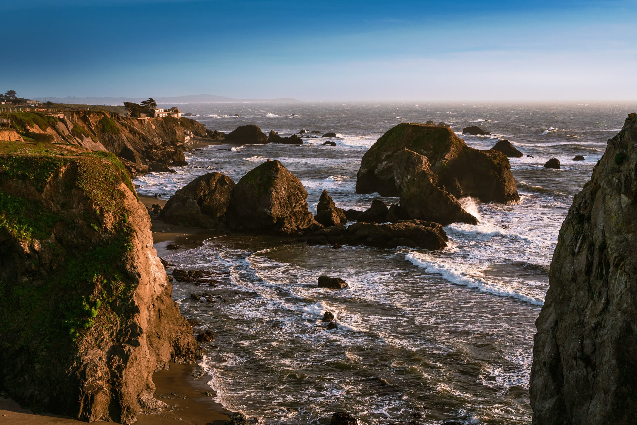 The Pacific Ocean surf churns around sea stacks at Rock Point Beach, Bodega Bay, California
