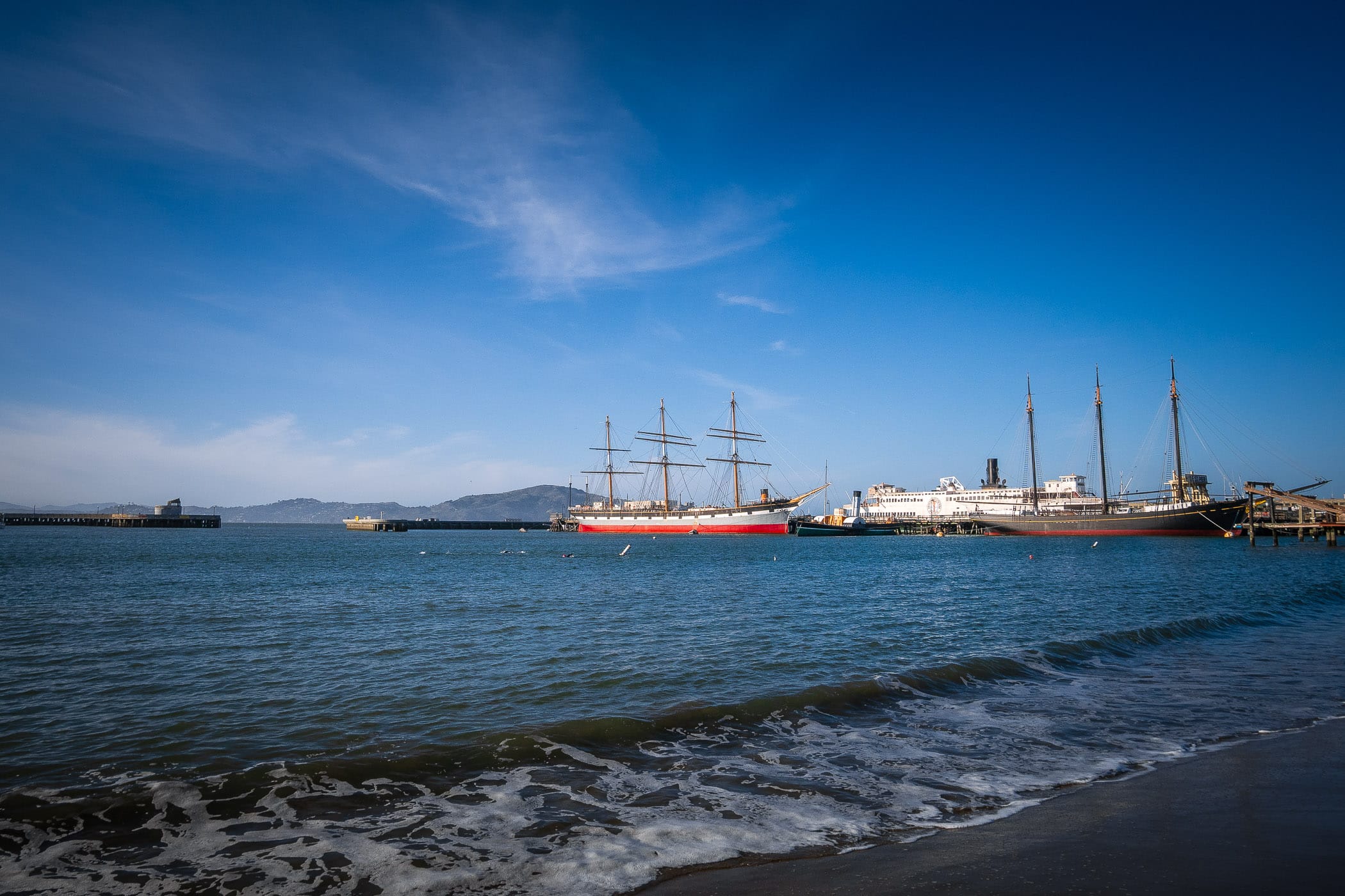 The tall masts of the historic ships Balclutha and C.A. Thayer at the San Francisco Maritime National Historic Park.