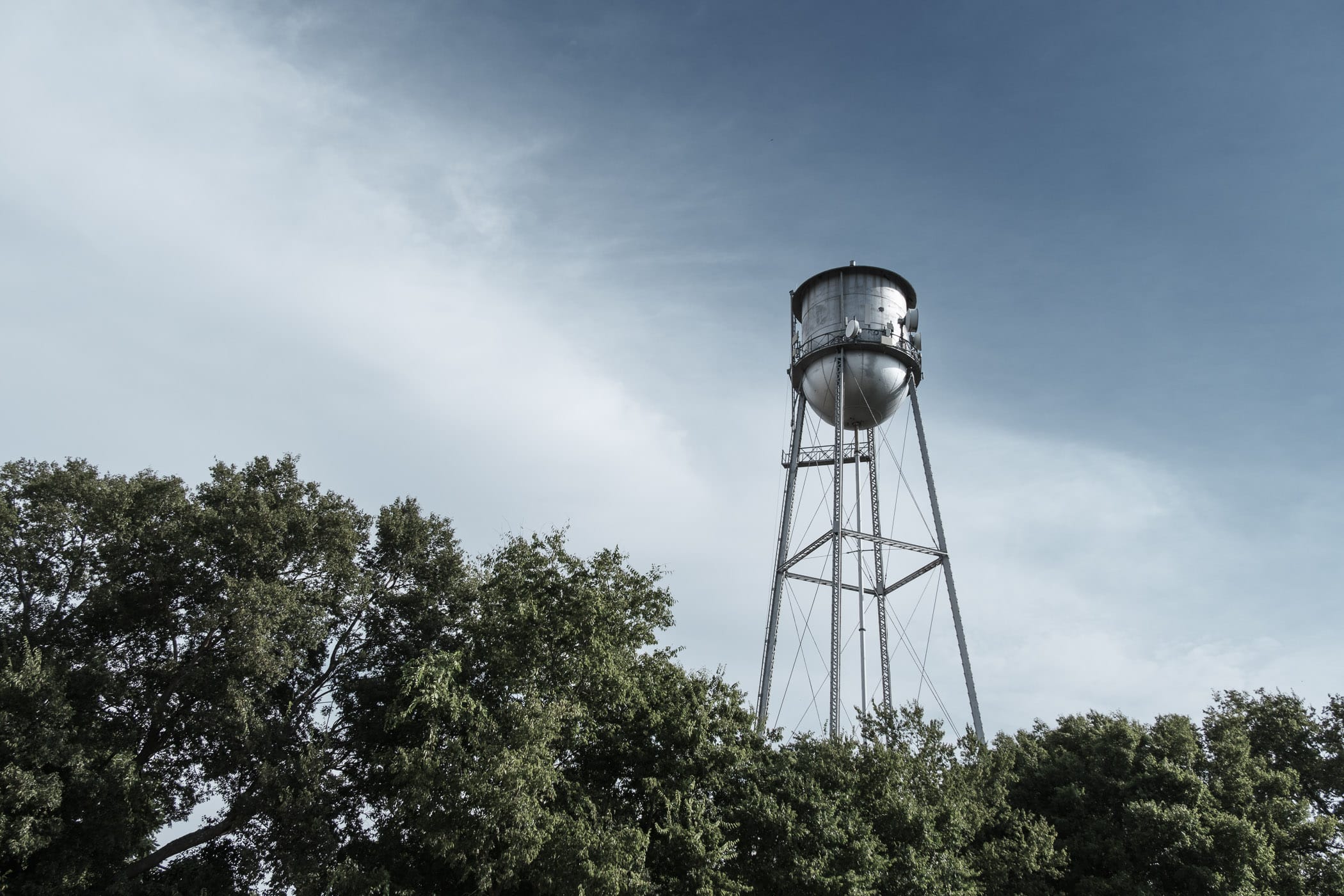 A water tower stands tall over trees in the small North Texas town of Trenton.