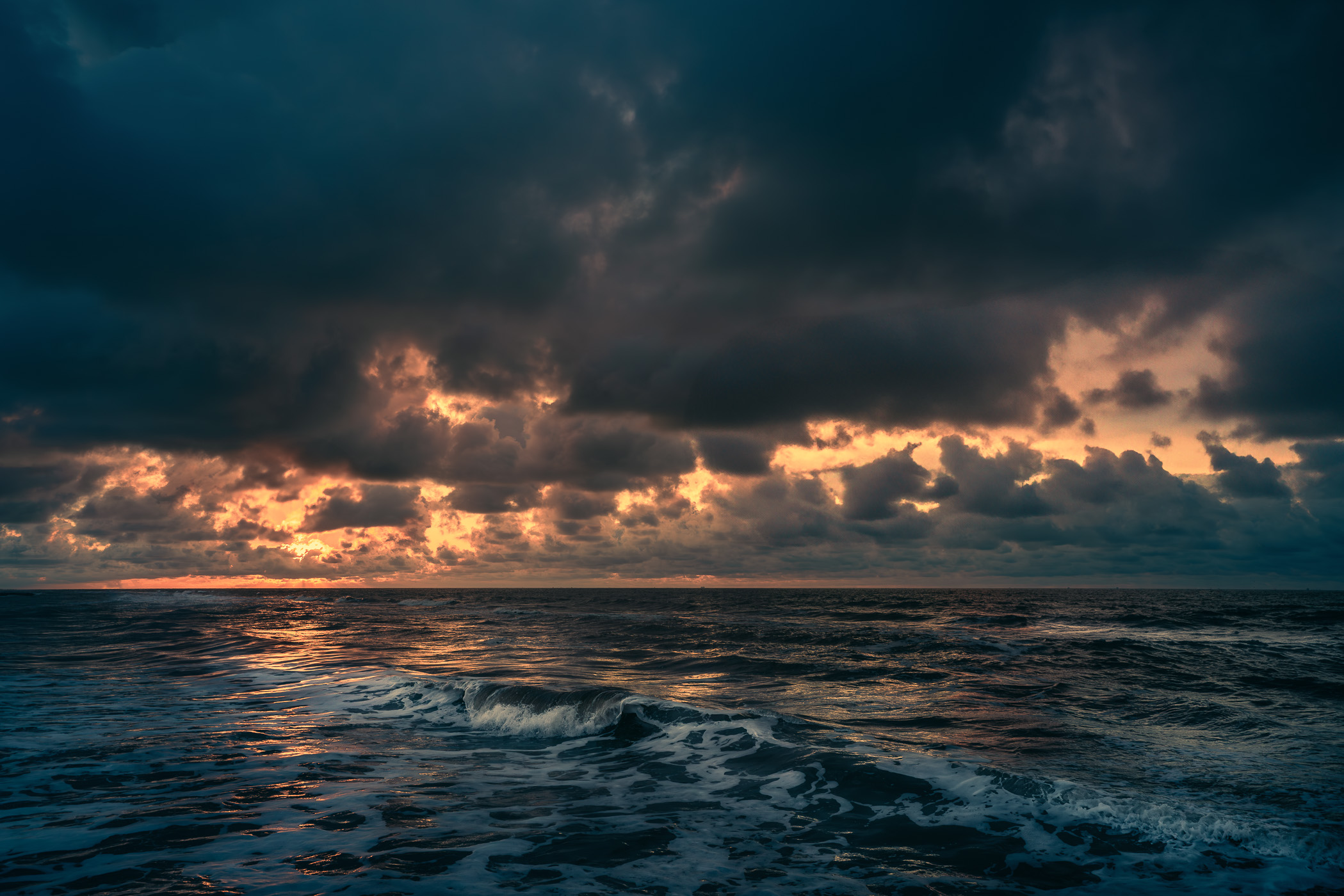 The sun begins to rise on the Gulf of Mexico as seen from Galveston, Texas.