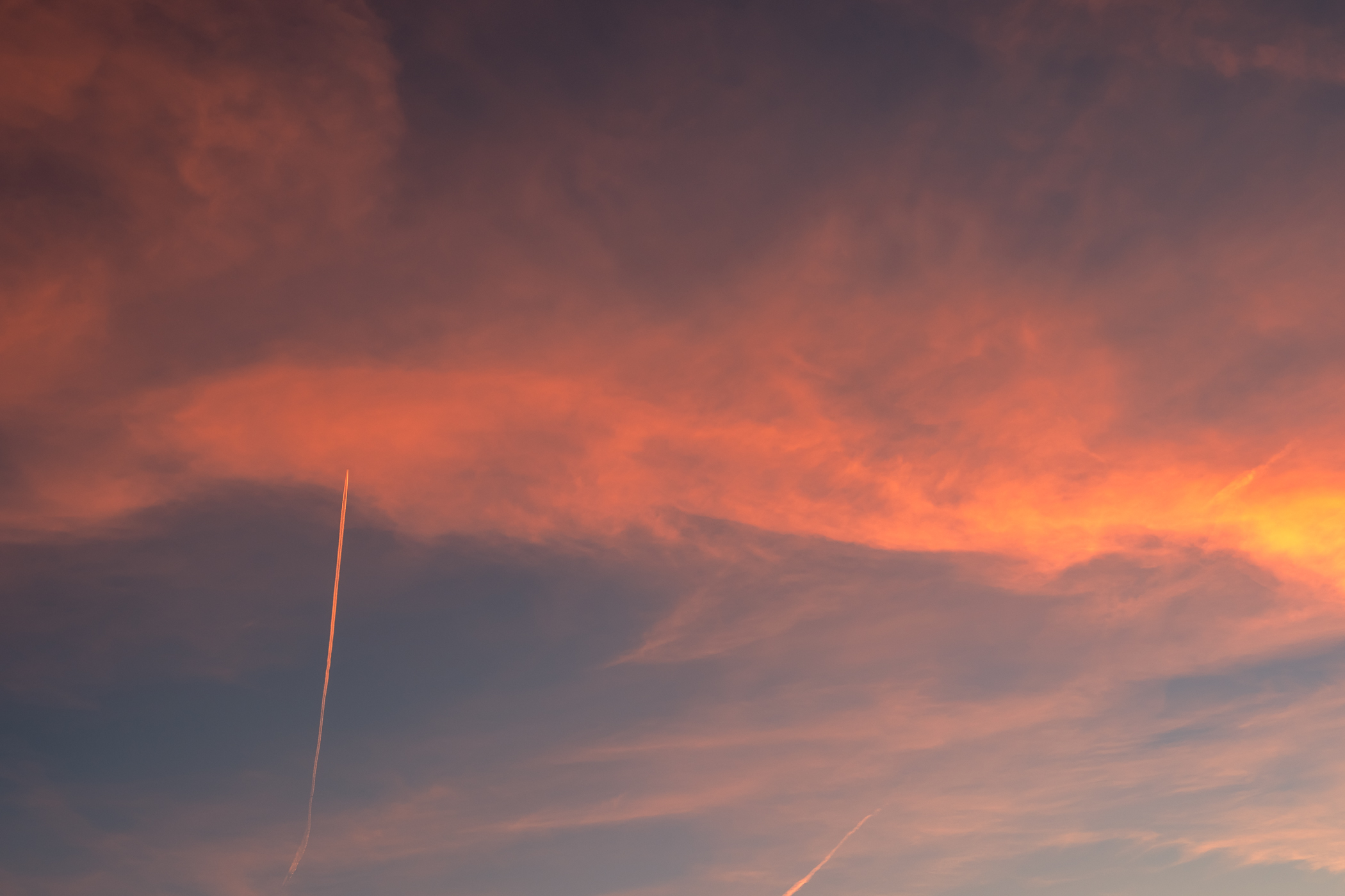 A jet leaves a contrail in the evening sky over the Dallas area as seen from McKinney, Texas.
