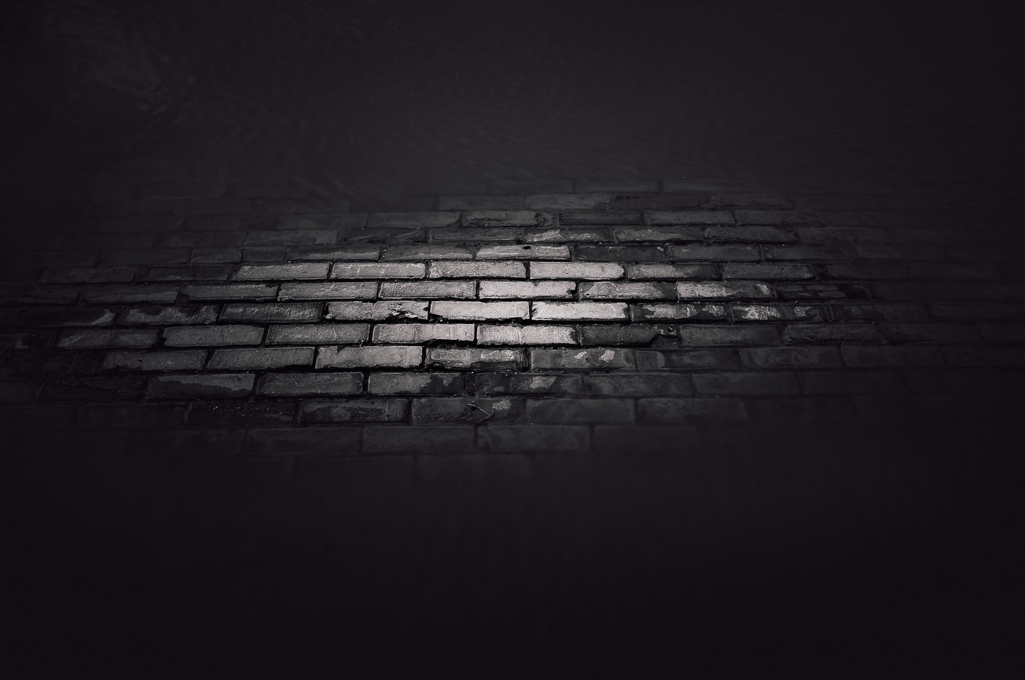 In the Historic Stockyards District of Fort Worth, Texas, the ghostly remnants of a brick street emerge through the waters left by a recent downpour, creating a hauntingly beautiful tableau.