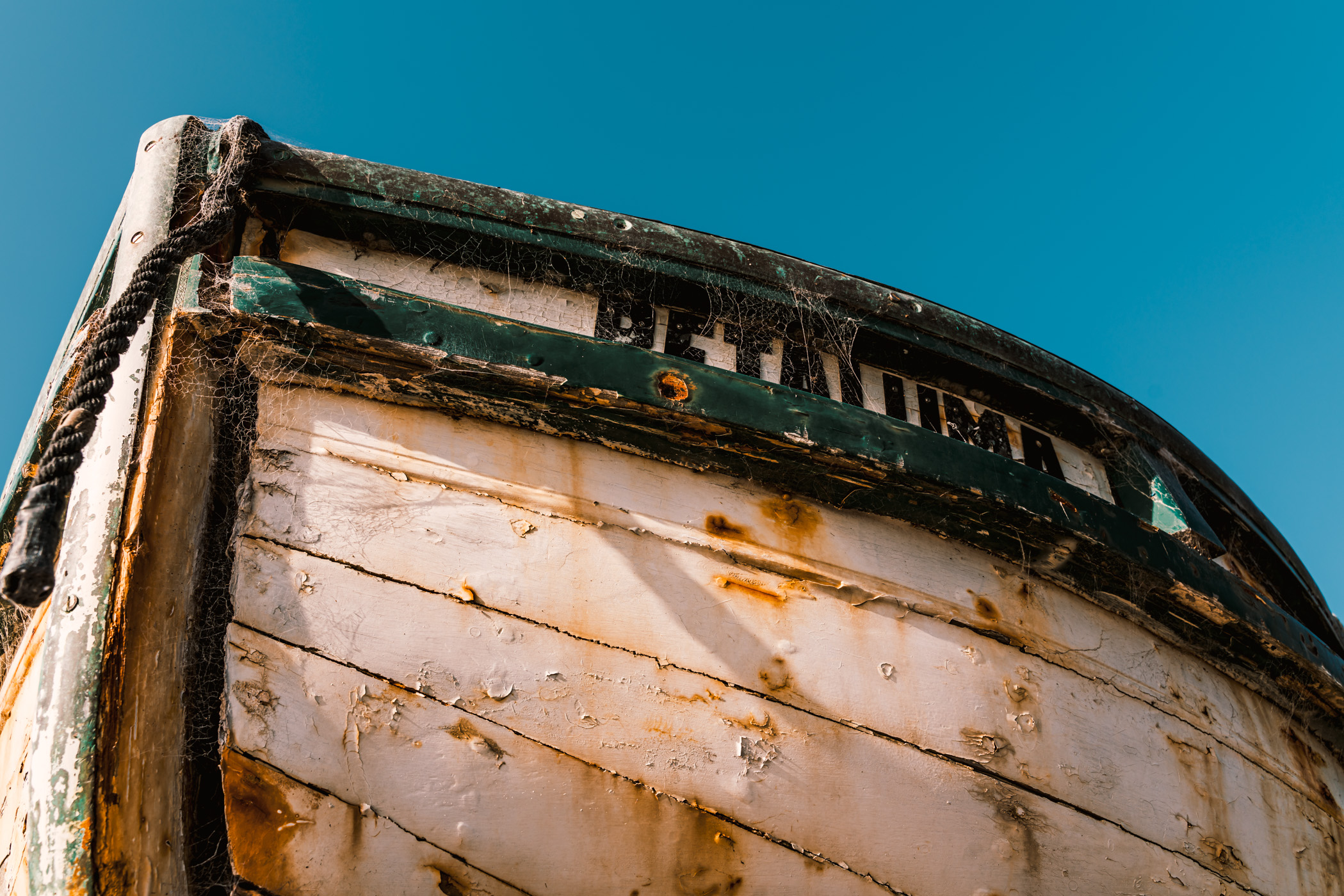An abandoned boat decays on the beach at China Camp Village, China Camp State Park, California.