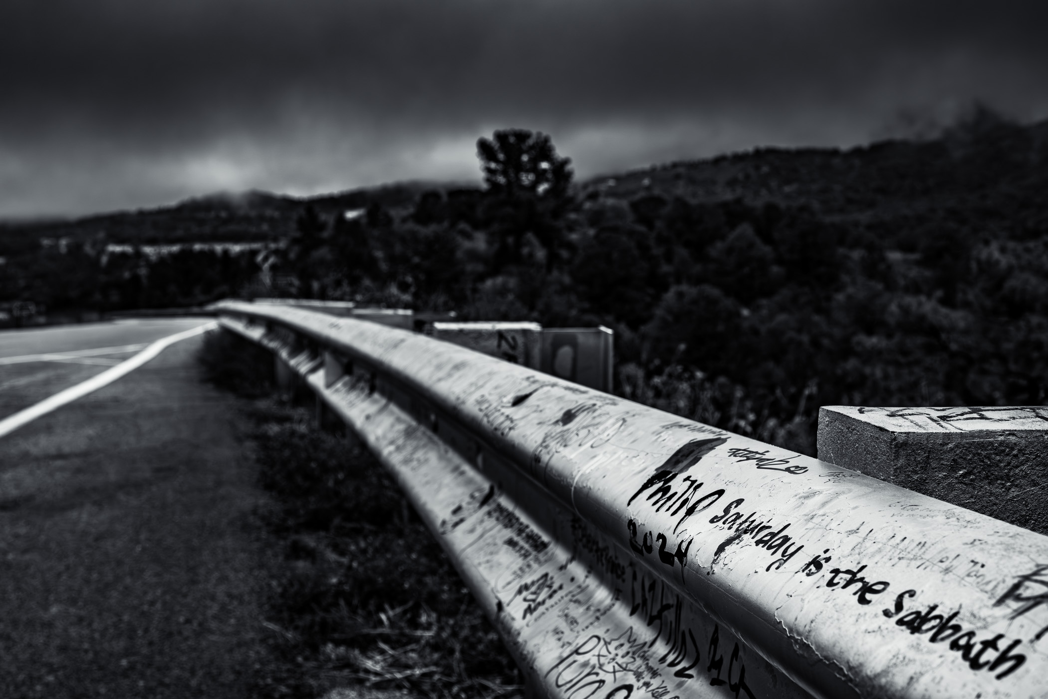 Graffiti on a roadside railing at Raton Pass—the mountain pass on Interstate 25 between New Mexico and Colorado.