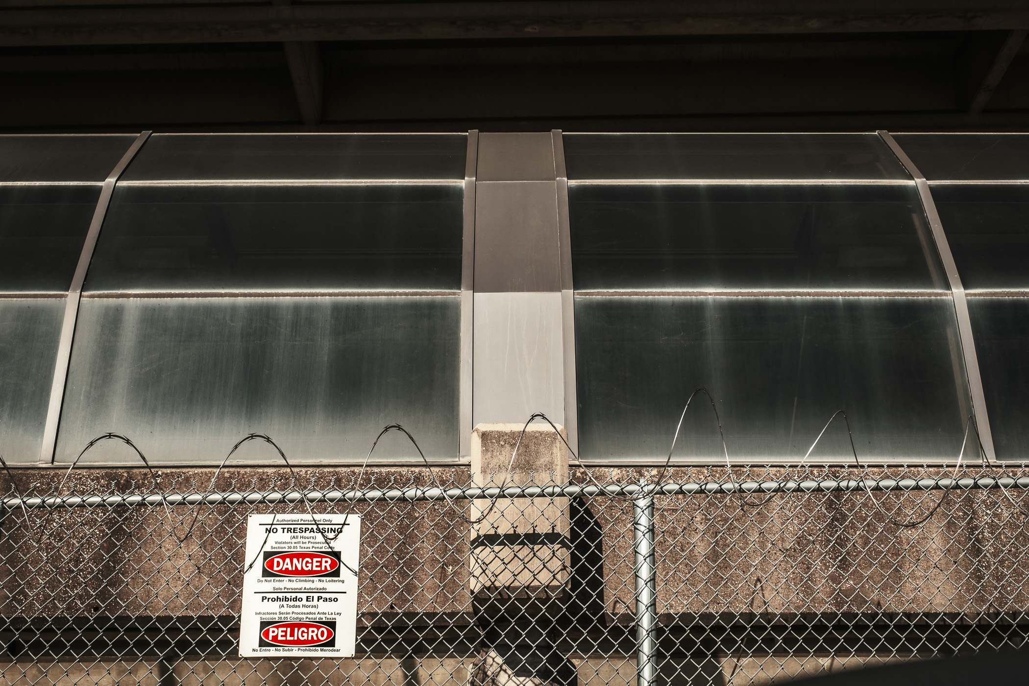 Razor wire atop a chainlink fence prevents intruders to an abandoned parking garage originally built for the now-demolished Reunion Arena near Downtown Dallas.