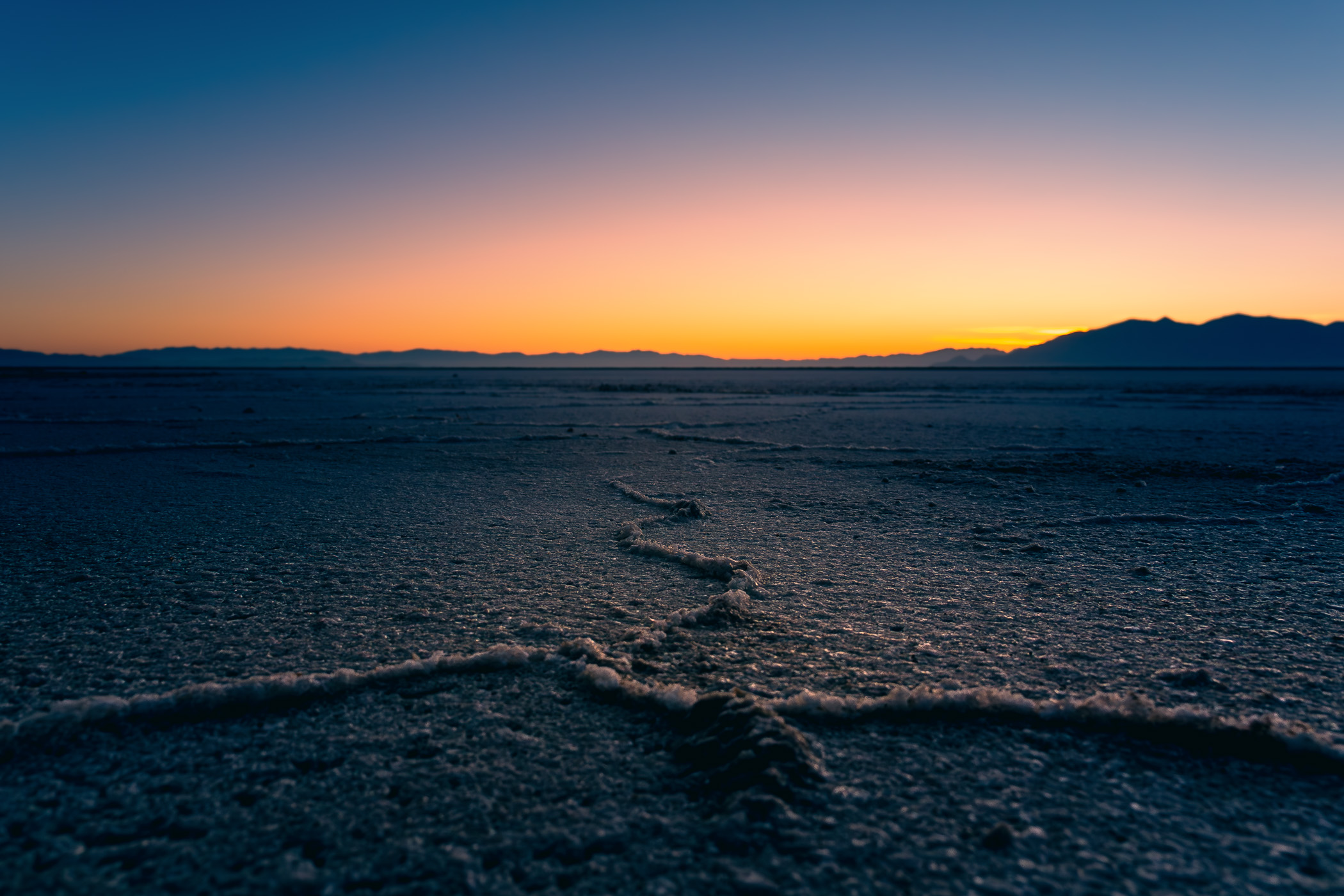 Salt flats stretch to the horizon along the shore of Utah's Great Salt Lake at Stansbury Island.