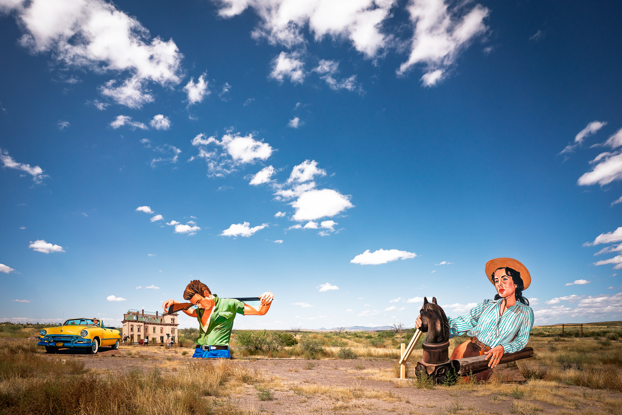 Muralist John Cerney’s "Giant Marfa" adds a vibrant touch to the desert near Marfa, Texas, featuring James Dean and Elizabeth Taylor in a tribute to Giant, the classic film shot in the area.