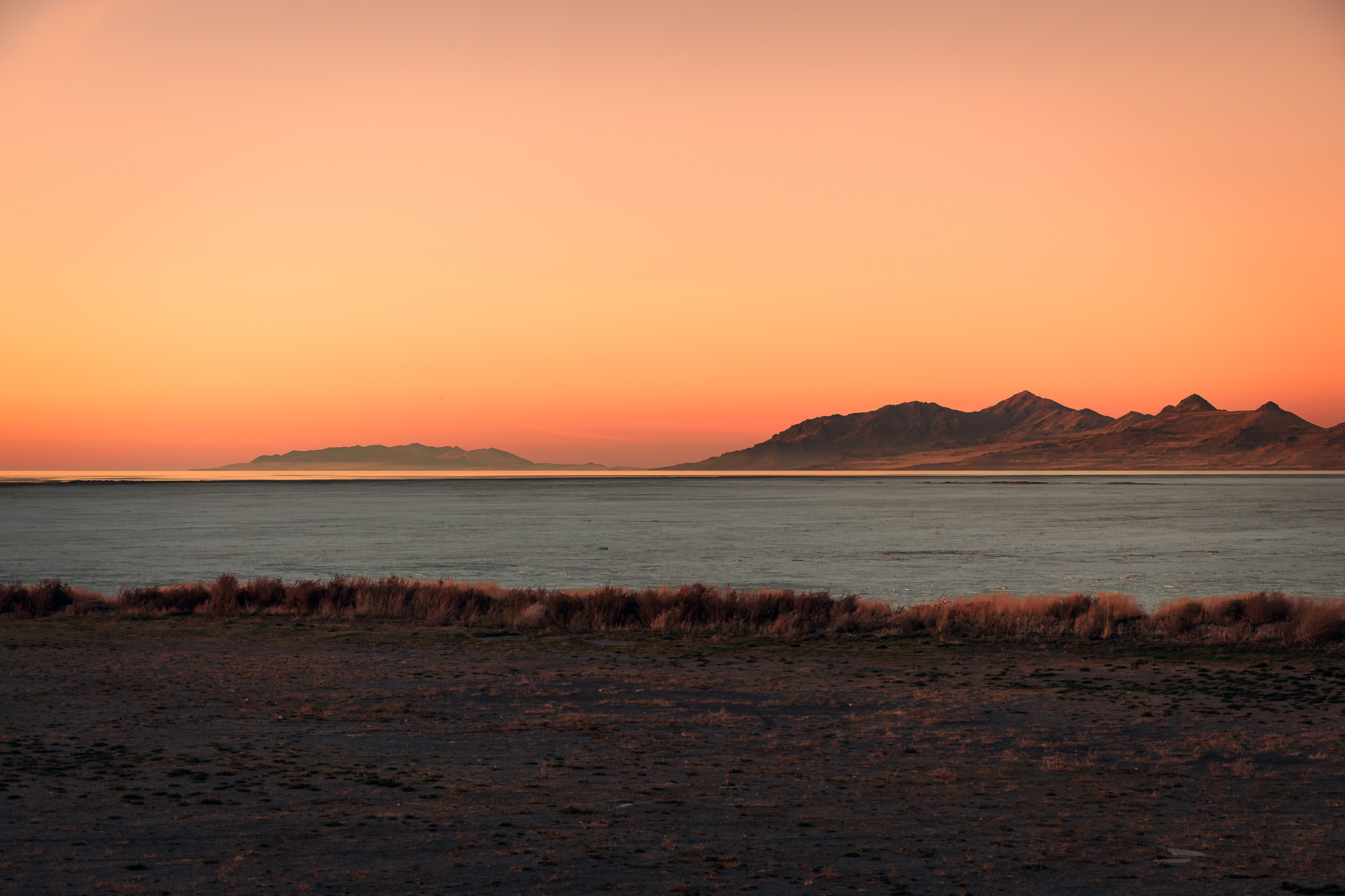 Late evening descends on salt flats along the shore of the Great Salt Lake near Magna, Utah.